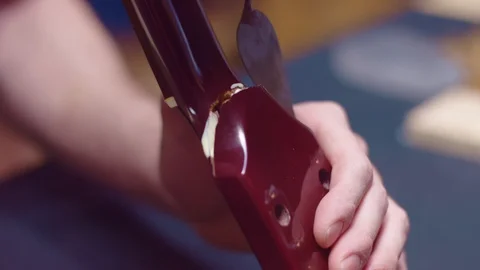 Guitar maker repairs guitar neck with glue Stock-Footage 105259095