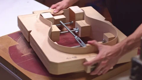 Guitar maker sanding a guitar Stock-Footage 117974110