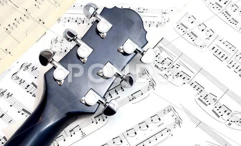 Guitar neck on notes Stock Photos