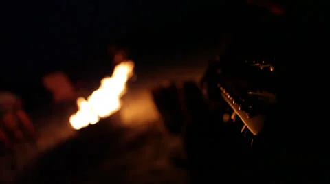 Guitar neck POV with rack to firepit Stock Footage 24636697