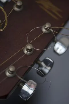 Guitar pick held between strings on neck. Guitar plectrum. Musical instruments. 스톡 사진