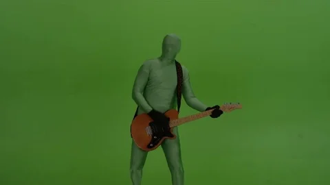 Guitar player on chroma key background, dressed in a greenscreen suit. Stock Footage 70725026