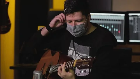 Guitar player in home recording studio in pandemic 库存影片 148501577