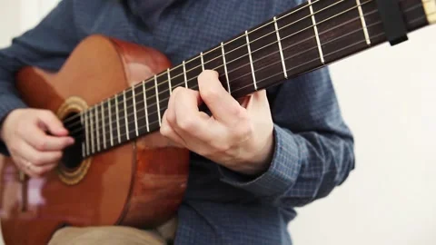 Guitar player man on a light romantic background with lights. Stock Footage 144988154