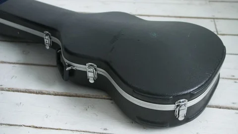 Guitar player opens guitar case Stock Footage 104044931