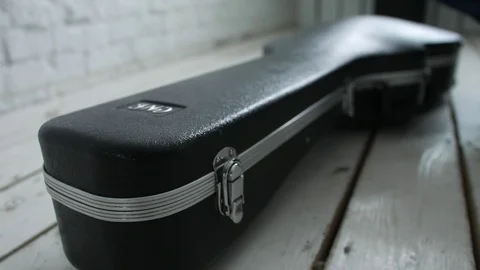 Guitar player opens guitar case Stock Footage 104044934