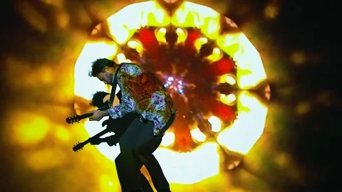 Guitar player performing in front of psychedelic back projection. Stock Footage 98851553