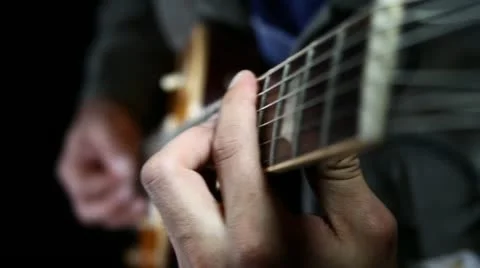 Guitar player playing chords with his left hand Stock Footage 21439817