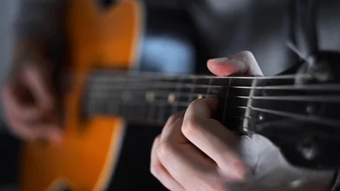 Guitar player plays random chords on the acoustic western guitar with steel Stock Footage 84173788