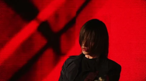 Guitar player on a red background Stock Footage 45997528