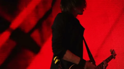 Guitar player on a red background Stock Footage 45997550