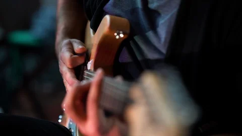 Guitar player sitting and playing E-Guitar and Stop Video stock 108104822