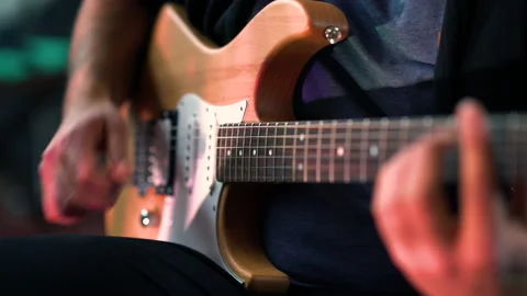 Guitar player sitting playing e-guitar | 4K Video stock 157812727