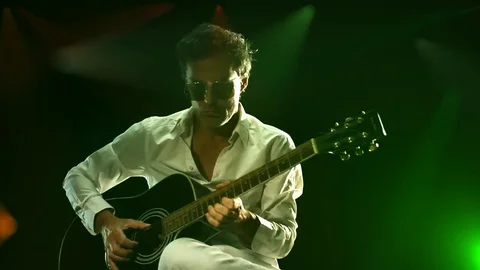 GUITAR PLAYER ON THE STAGE PLAYING ACUSTIC GUITAR Stock Footage 74764462
