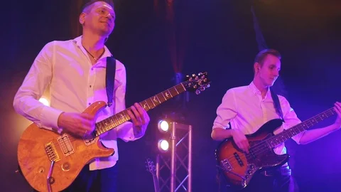 Guitar player on stage in the rays of light. A party, rock, playing music. Stock Footage 108426590