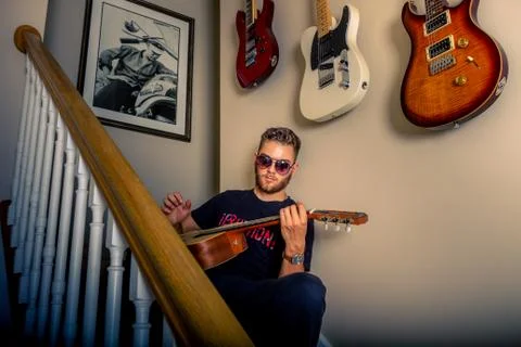 Guitar player on the steps Stock Photos