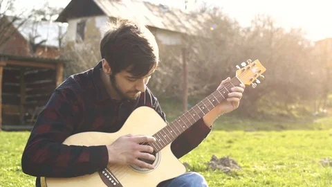 Guitar playing. Alone man playing on a guitar outdoors. Playing music Stock Footage 109179563