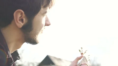Guitar playing. Alone man playing on a guitar outdoors. Nature Stock Footage 109179613