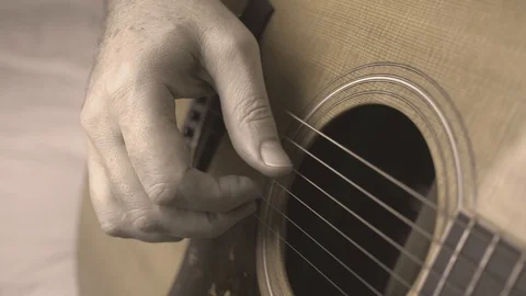 Guitar playing closeup, black and white hand finger picking acoustic guitar Stock Footage 101314241