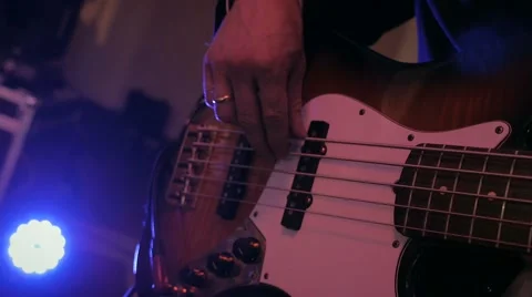 Guitar playing in the dark in violet lights at the wedding party Stock Footage 65187773