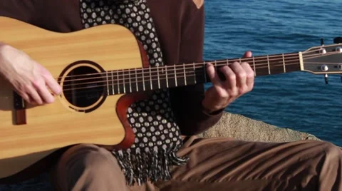 Guitar playing on the seashore Stock Footage 61694821