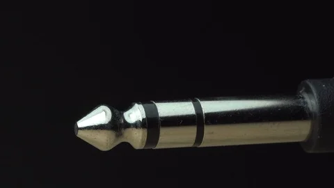 Guitar plug isolated macro light sweep shadow dimly lit Stock Footage 119120133