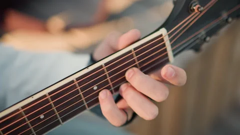 Guitar practice scene. Focused shot of fingers demonstrating chord techniques Stock Footage 327987287