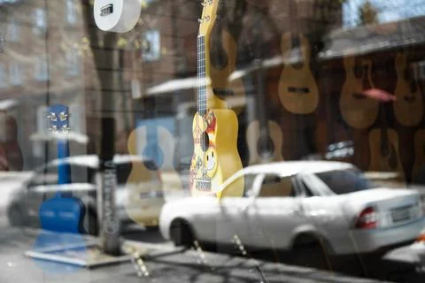 Guitar reflection toy window small yellow blue Stock Photos
