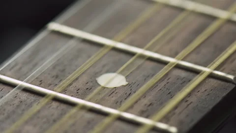 Guitar strings are vibrating from fingering. Macro shot Stock Footage 325639666
