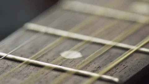 Guitar strings are vibrating from fingering. Macro shot 動画素材 346662893