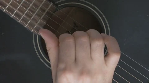 Guitar strings closeup. A man plays gitare Stock Footage 73976142