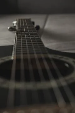 Guitar strings create a melody of shadows and light in an artistic setup Stock Photos