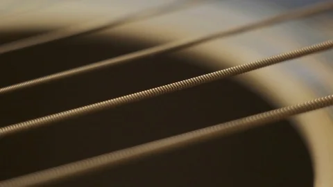 Guitar strings vibrate after being touched, close-up Stock Footage 123709240