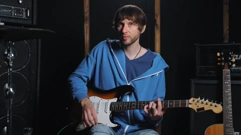 The guitar teacher explaining about the elements of the electric guitar Stock Footage 265013840