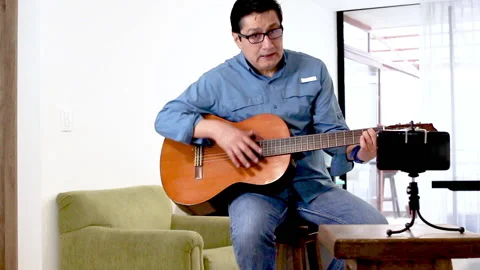 Guitar teacher teaching chords during a class Stock Footage 147229783