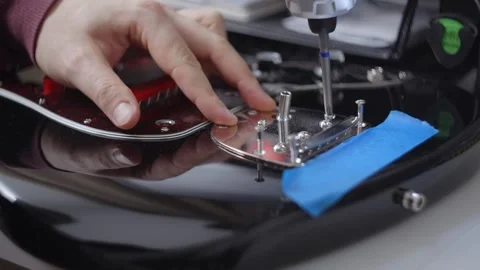 Guitar tech disassembles the vintage guitar, repair of the musical instruments Stock Footage 282880498