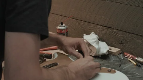 Guitar Tech Working on Electric Guitar on Bench Stock Footage 126922354