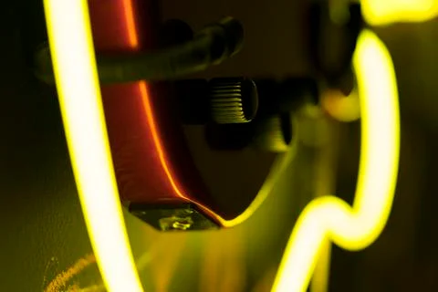 Guitar tone knobs surrounded by neon light, bass, artistic background Stock Photos