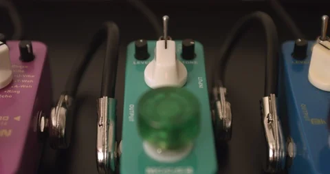 Guitarist Adjusting Knobs And Switches On Overdrive Guitar Effect Pedal 스톡 동영상 114638695