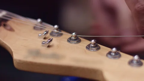 Guitarist changes the strings of the guitar Stock Footage 102056451