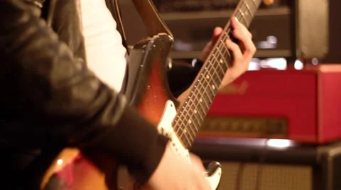 Guitarist. Close-up on a male hand playing hard on a electric guitar. Defocus 動画素材 59552168