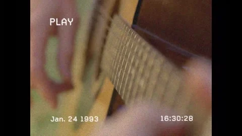 Guitarist picking strings after camera focus on picking, fretting chords, tape Stock Footage 328384340