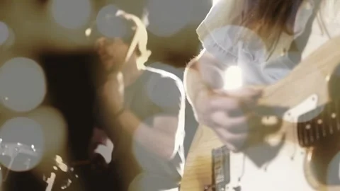 Guitarist playing guitar on stage, causing pullback revealing drummer, bokeh Video stock 333894331