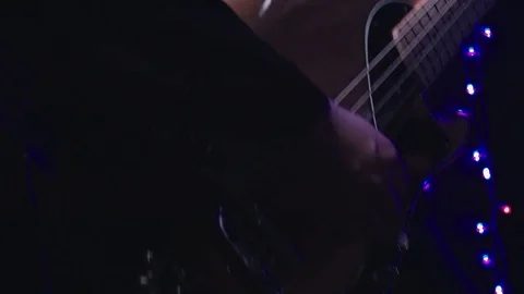 Guitarist plays bass guitar close-up Stock Footage