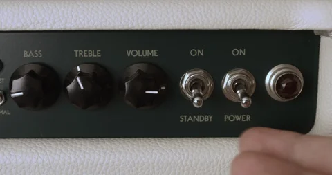 Guitarist Powering On And Adjusting Knobs On Tube Amp. Dolly Shot. Video stock 114640963