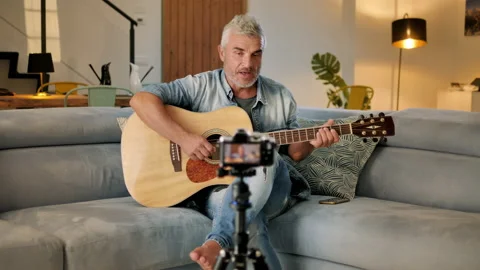 Guitarist vlogger makes video tutorial on how to play guitar 動画素材 139750922
