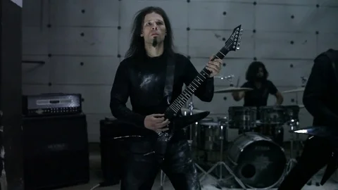 Guitarists playing in hangar Stock Footage