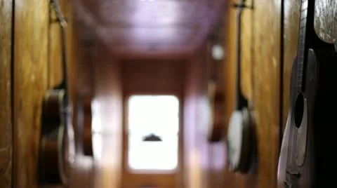 Guitars and Stringed Instruments Hanging on Walls Vídeos de archivo 21236340