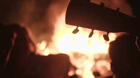 Guitars Being Played Around A Campfire Vídeo Stock 70405787