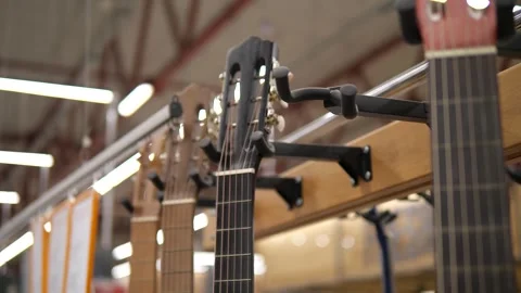 Guitars hanging on hooks. Musical instruments. Stock Footage 311966732